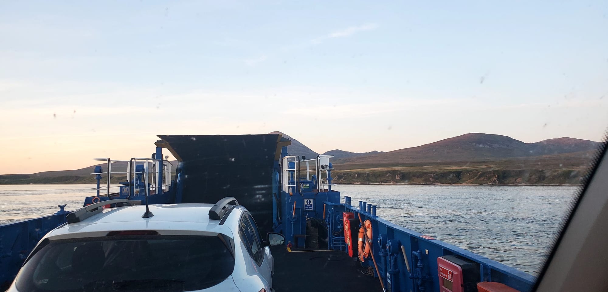 Cars drive on to the small ferry.