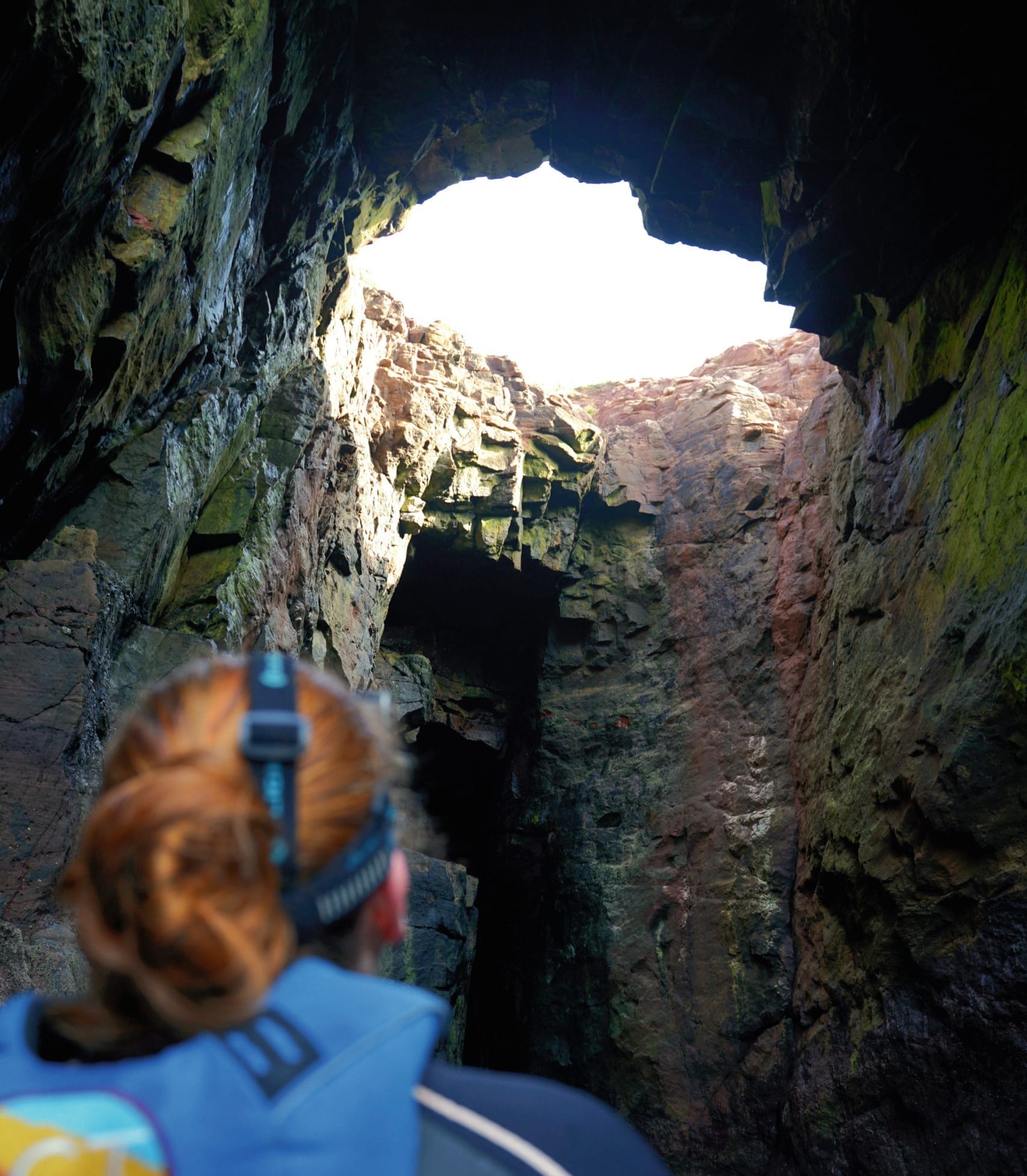 Jacki is looking up towards the Blowhole in the rock.
