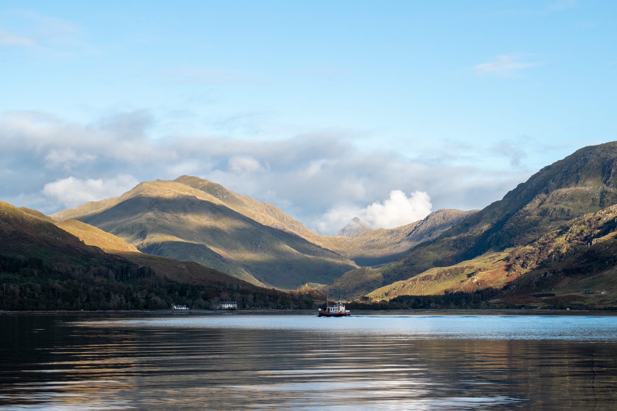 A view across the water to golden mountains by Inverie.