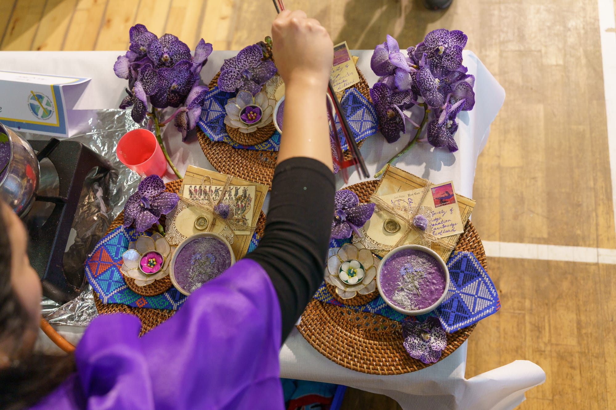 Kim McGhee cooking at her station with ube (purple yam).