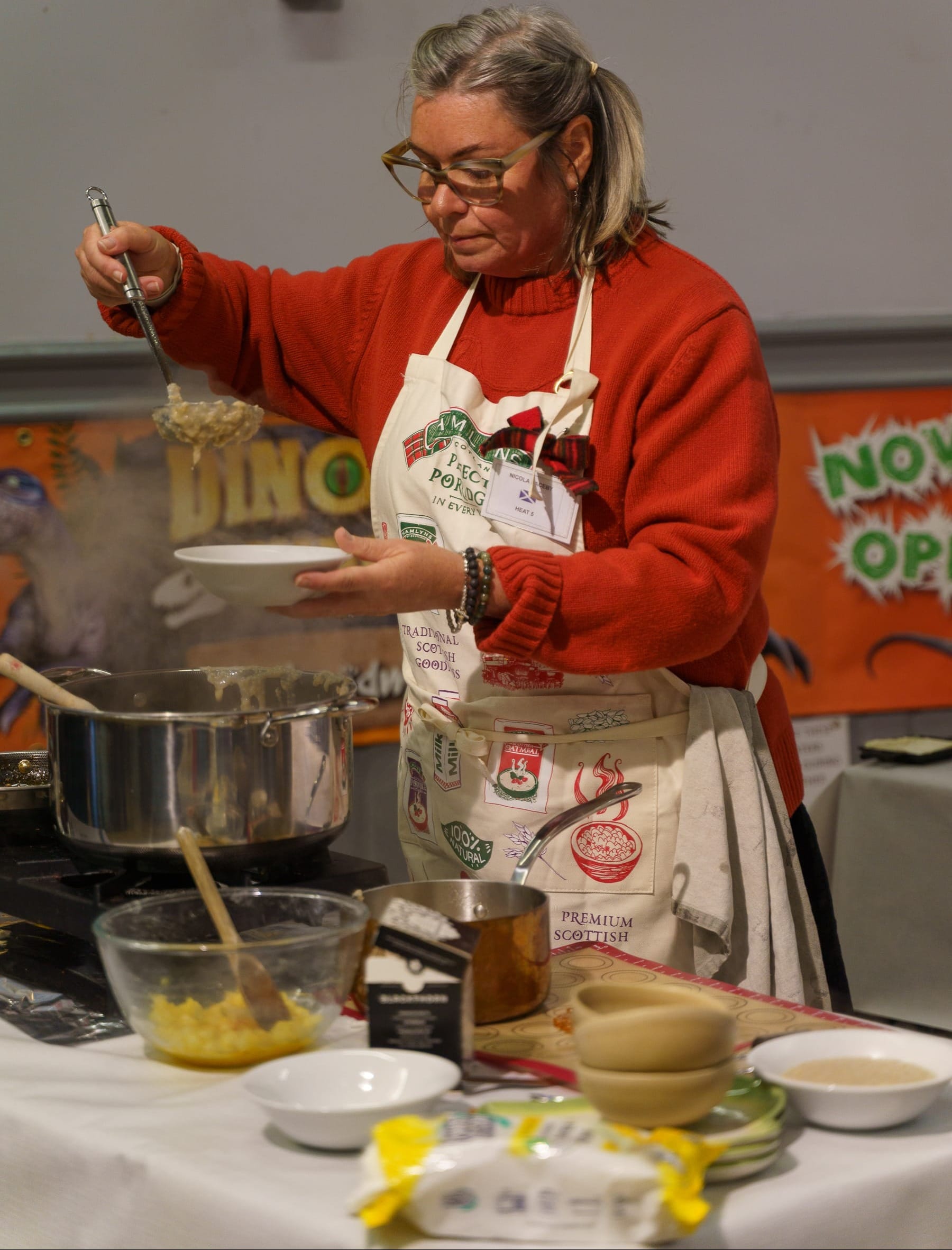 Nicky Laceby ladles porridge into a bowl at her station.