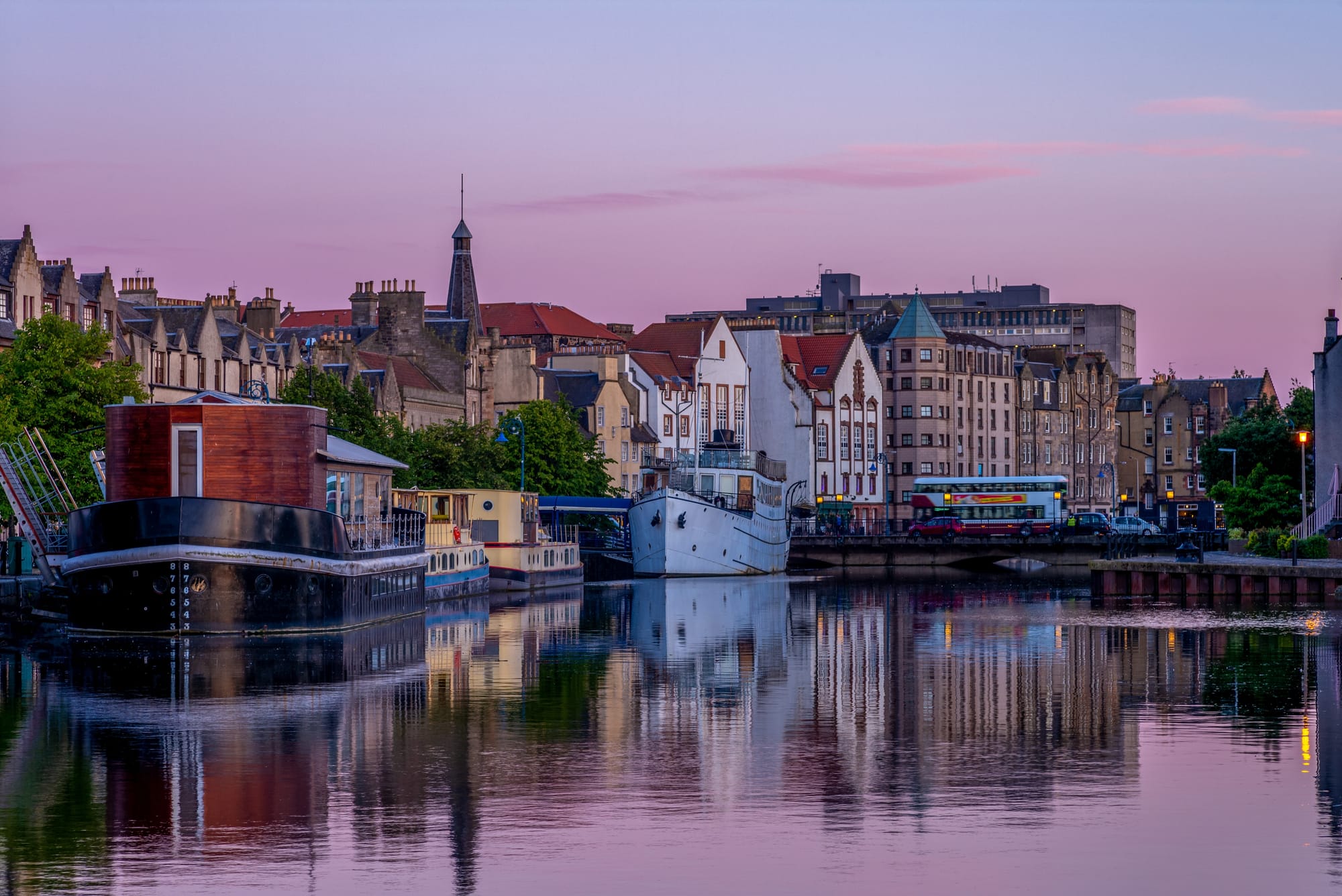 Houses and boats lining the Water of Leith.