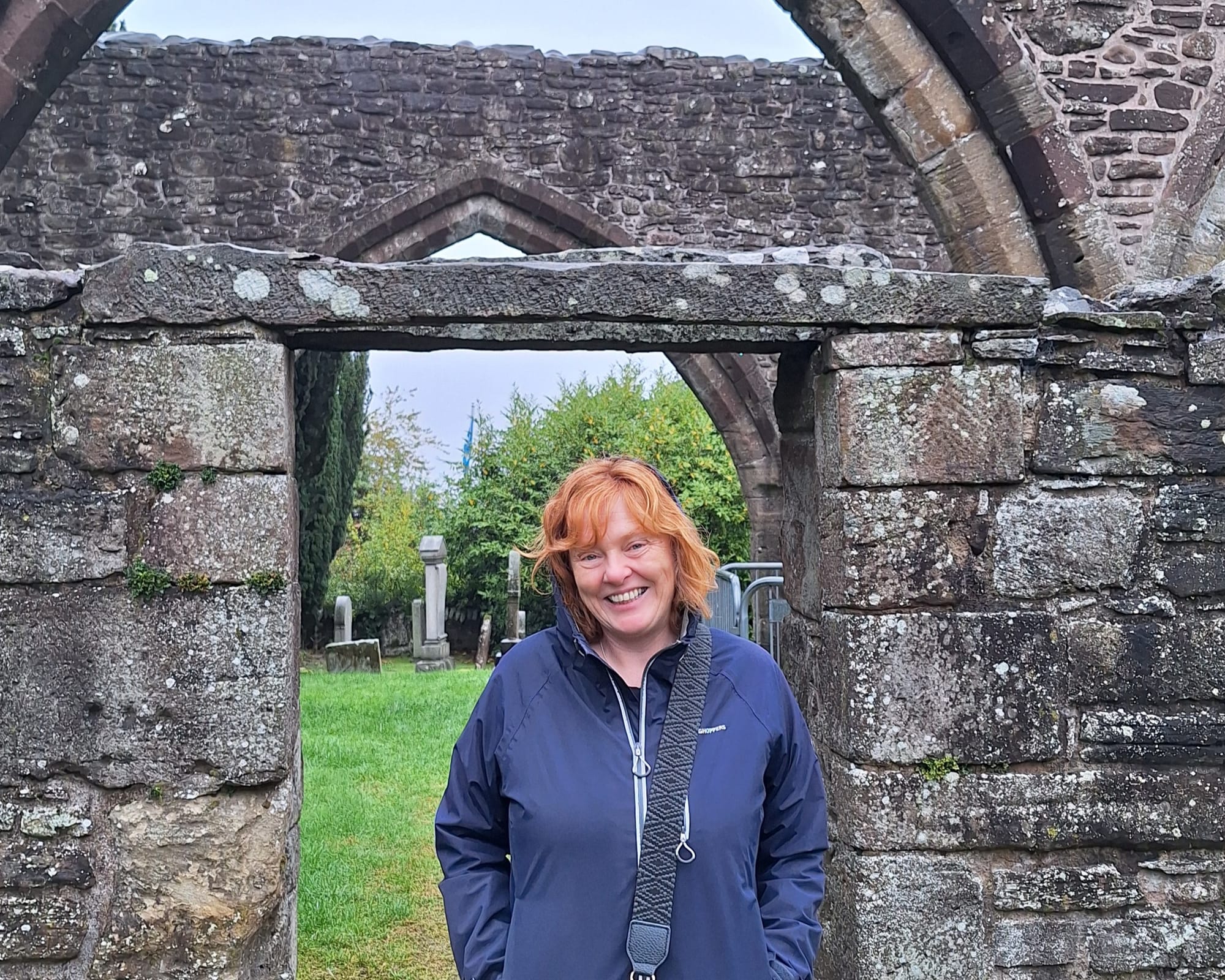 Beth's mum smiles in the church grounds.