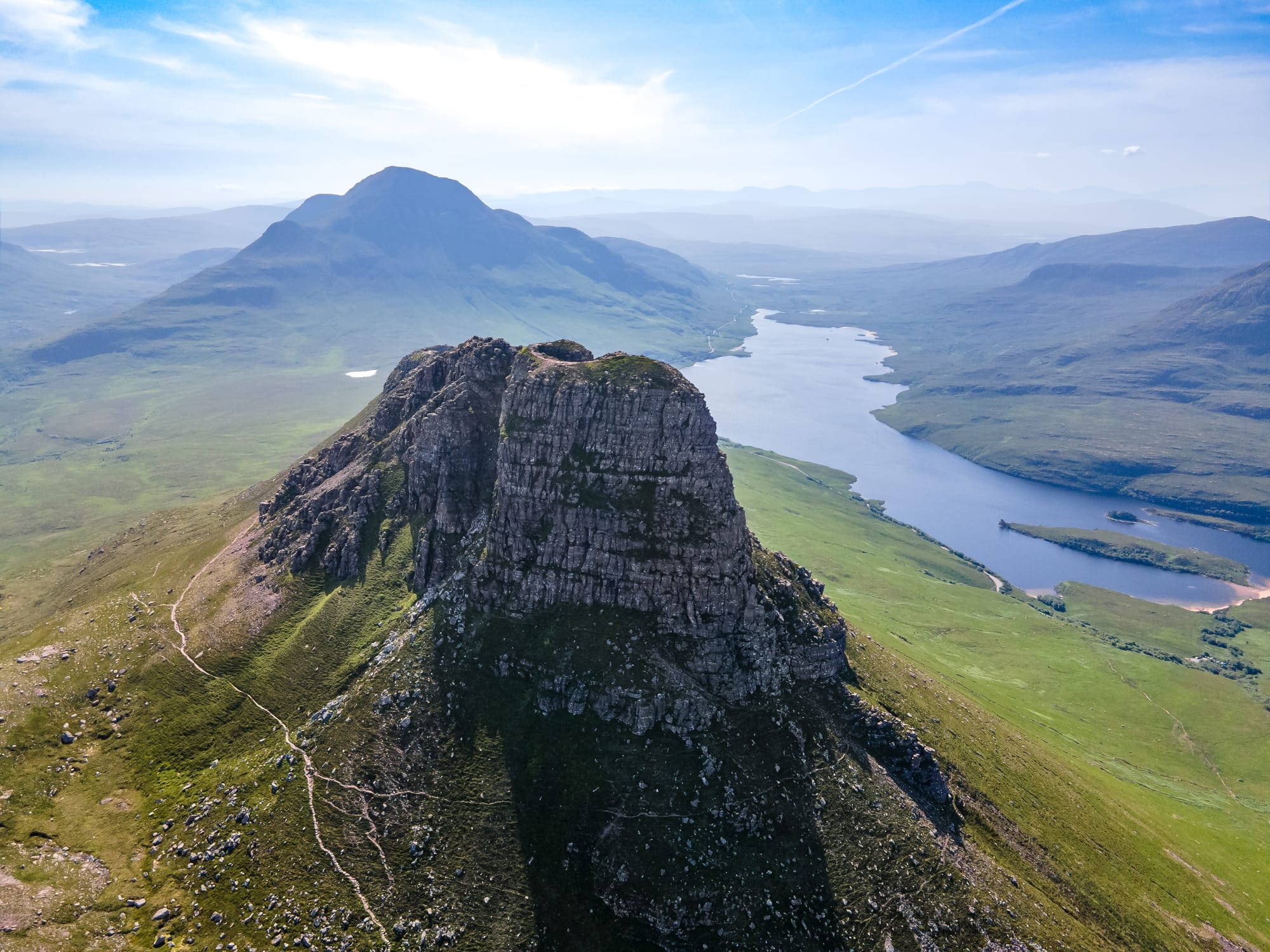 An aerial shot showing Stac Pollaidh with a loch in the background.