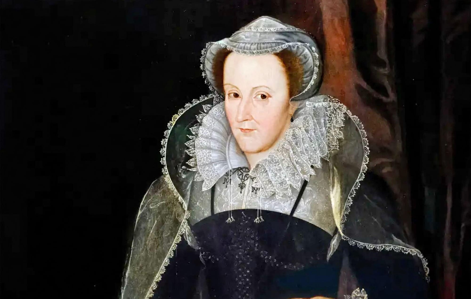 A portrait of Mary showing her trademark auburn hair and in dark robes.