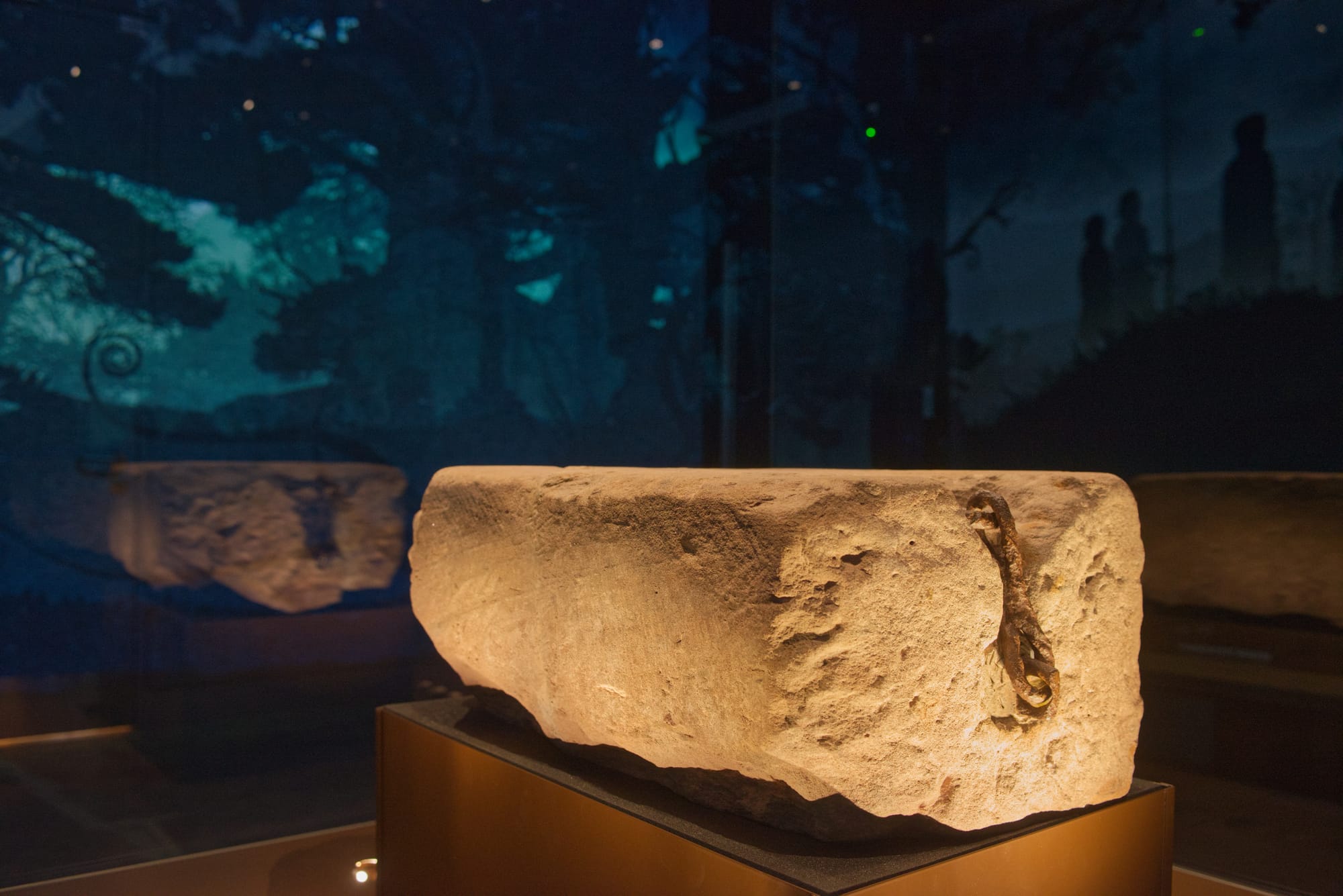 An up-close shot of the Stone of Destiny displayed in Perth Museum. The iron handles are visible on the side.