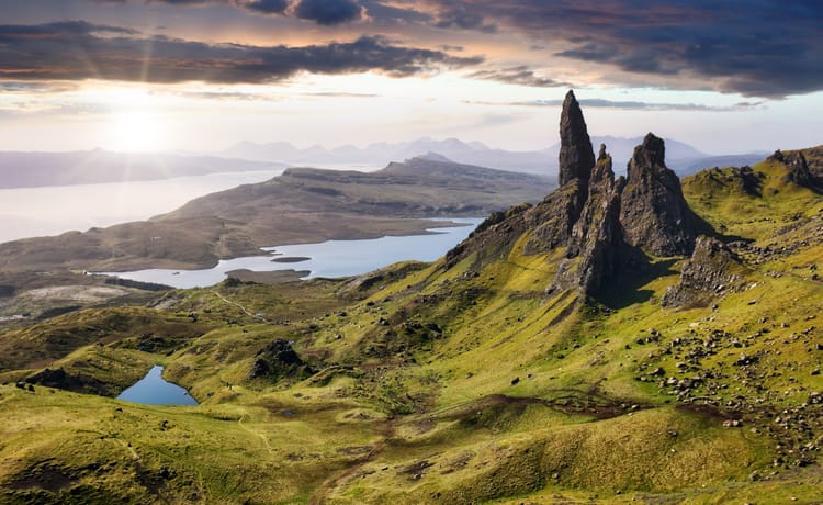 An aerial view of the Old Man of Storr with dramatic clouds in the background.